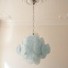 Blue swirled Murano glass disc chandelier under an ornate ceiling rose