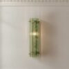 Green Murano triedri column wall sconce lit on a panelled wall in a Stockholm apartment