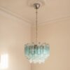 Handblown Murano Quadriedri Chandelier – 107 Quadriedri Glass under an ornate ceiling rose