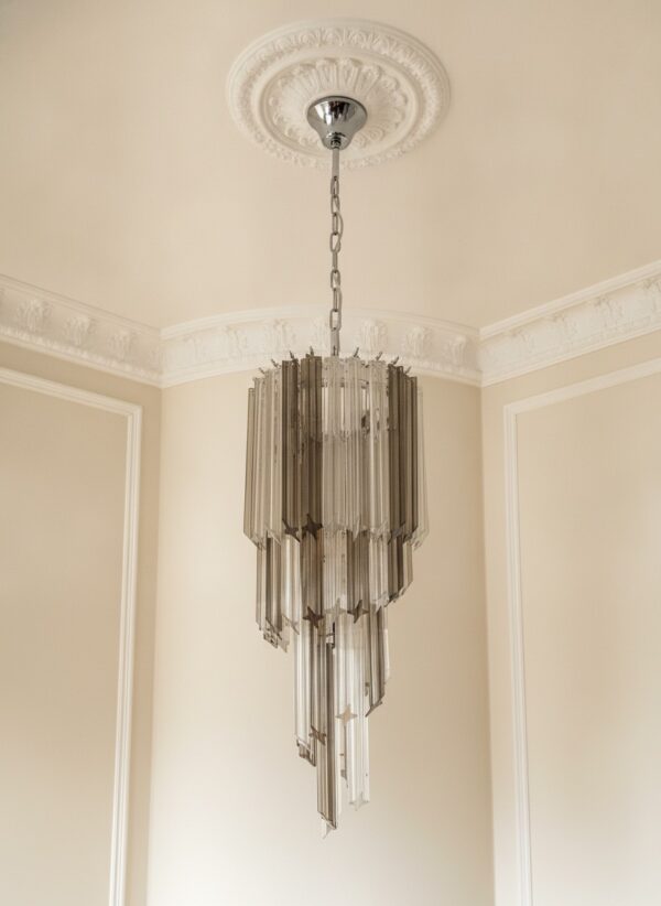 Handblown Murano Quadriedri Chandelier – 54 Quadriedri Glass under an ornate ceiling rose
