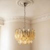 Handblown Murano Triedri Chandelier – 107 Triedri Glass under an ornate ceiling rose
