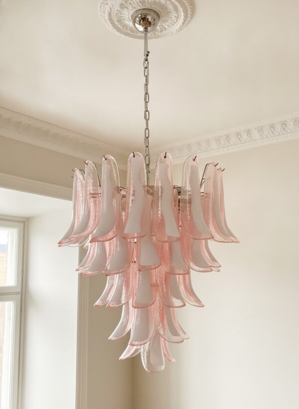 Pink Murano petal chandelier hanging from an ornate ceiling rose in a Stockholm apartment