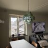 Green Murano disks chandelier above a dining table