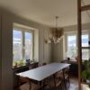 Multicolour Murano tubular chandelier above a dining table by the window