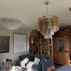 Multicolour Murano tubular chandelier with amber, smoked and clear glass prisms in a living room
