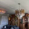 Multicolour Murano tubular chandelier with 36 glass prisms above a living room sofa