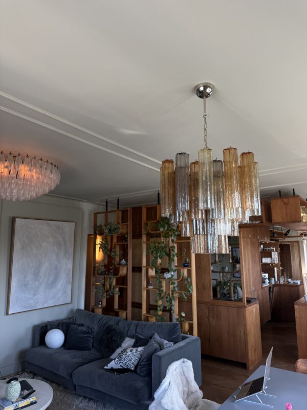 Multicolour Murano tubular chandelier with 36 glass prisms above a living room sofa