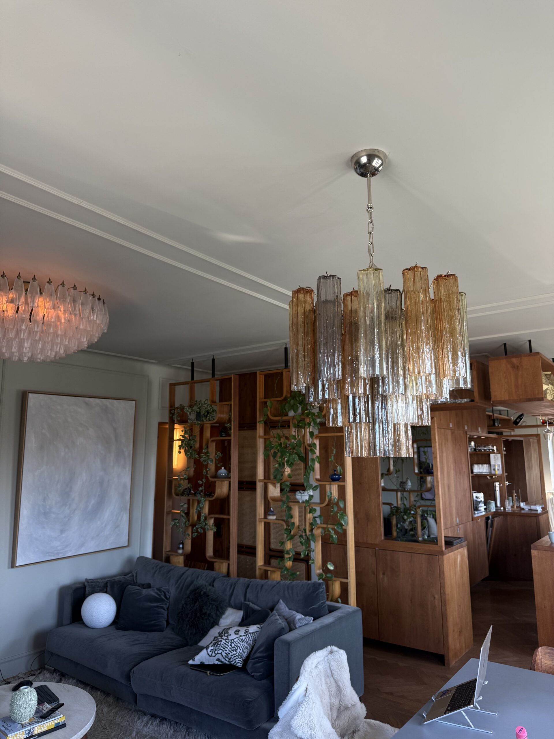 Multicolour Murano tubular chandelier with 36 glass prisms above a living room sofa