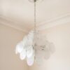 Transparent Murano Disks Chandelier under an ornate ceiling rose