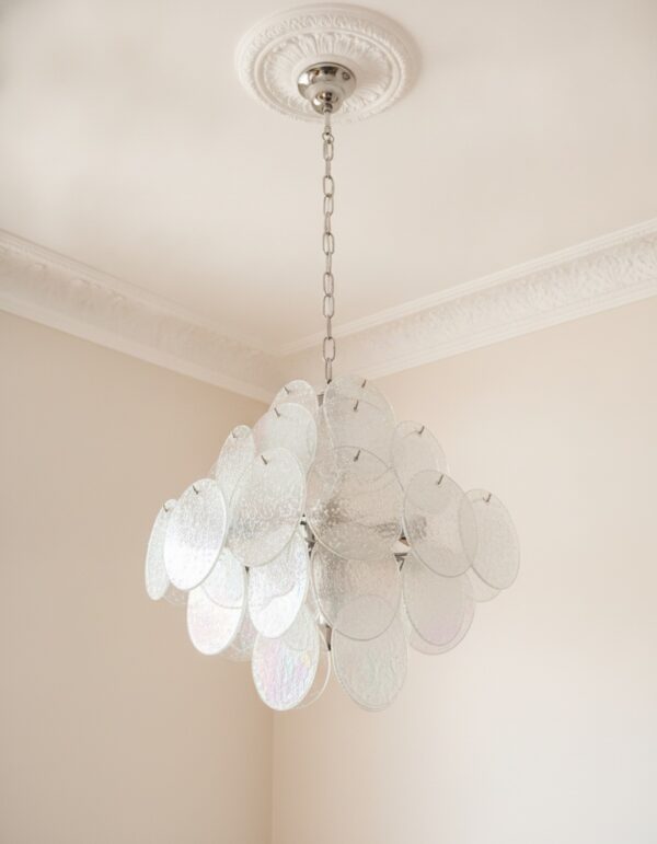 Transparent Murano Disks Chandelier under an ornate ceiling rose